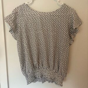 White blouse with black/purple dots cinched at bottom